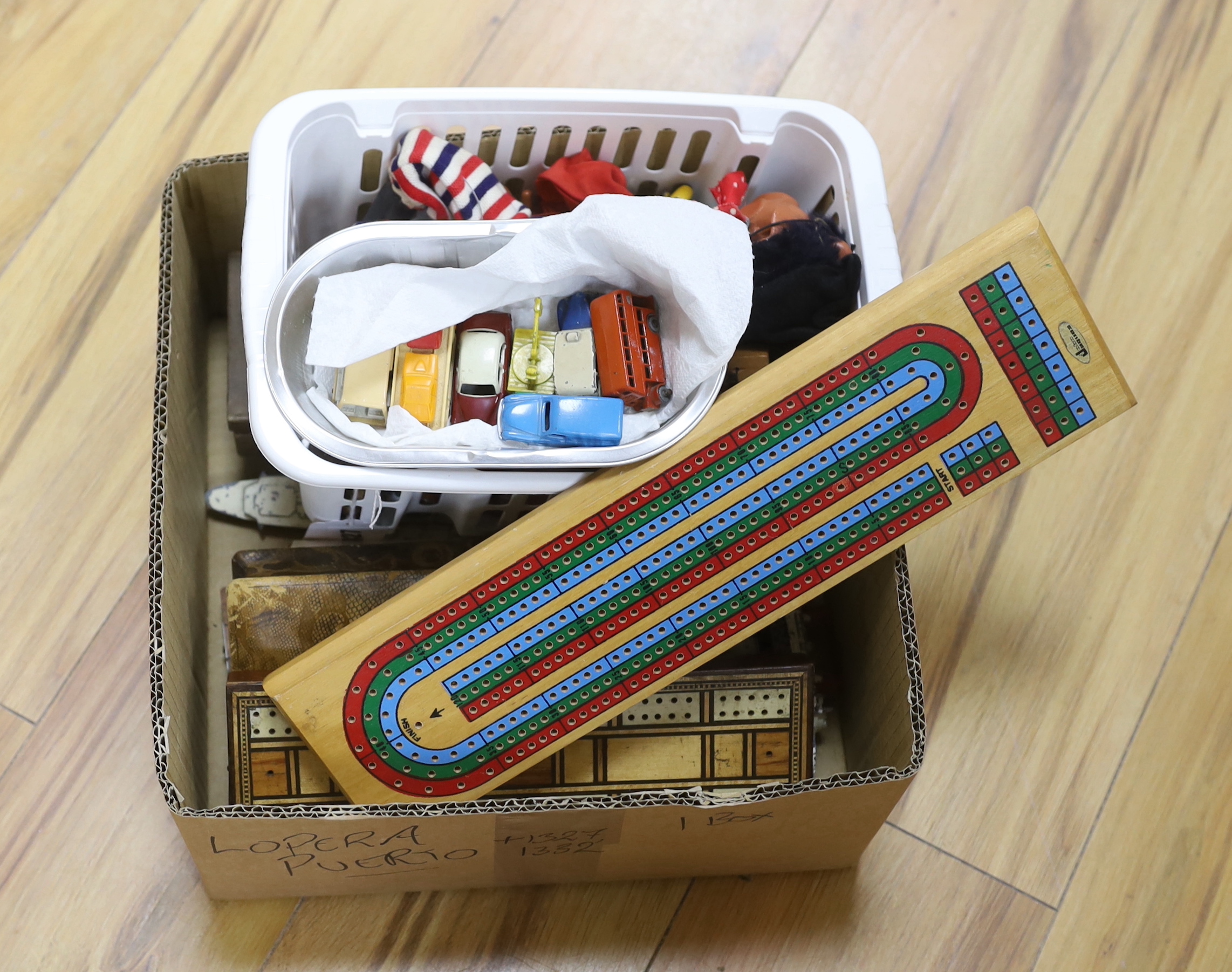 A quantity of toys including Dinky, Pelham puppet and cribbage board, the largest 38cm wide